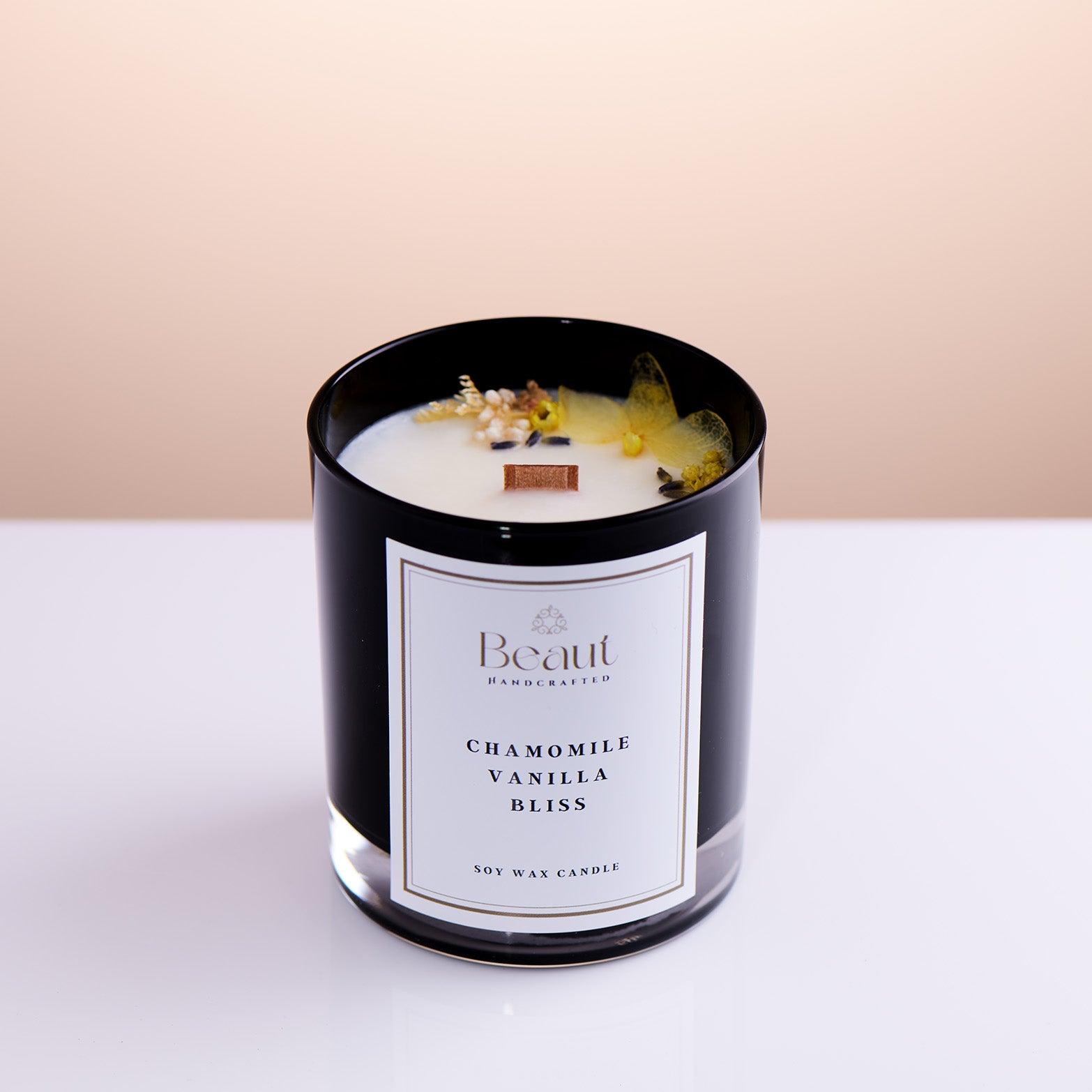 candle in black glass container photographed in angle to show full beauty of the design, wooded wick and overal candle look